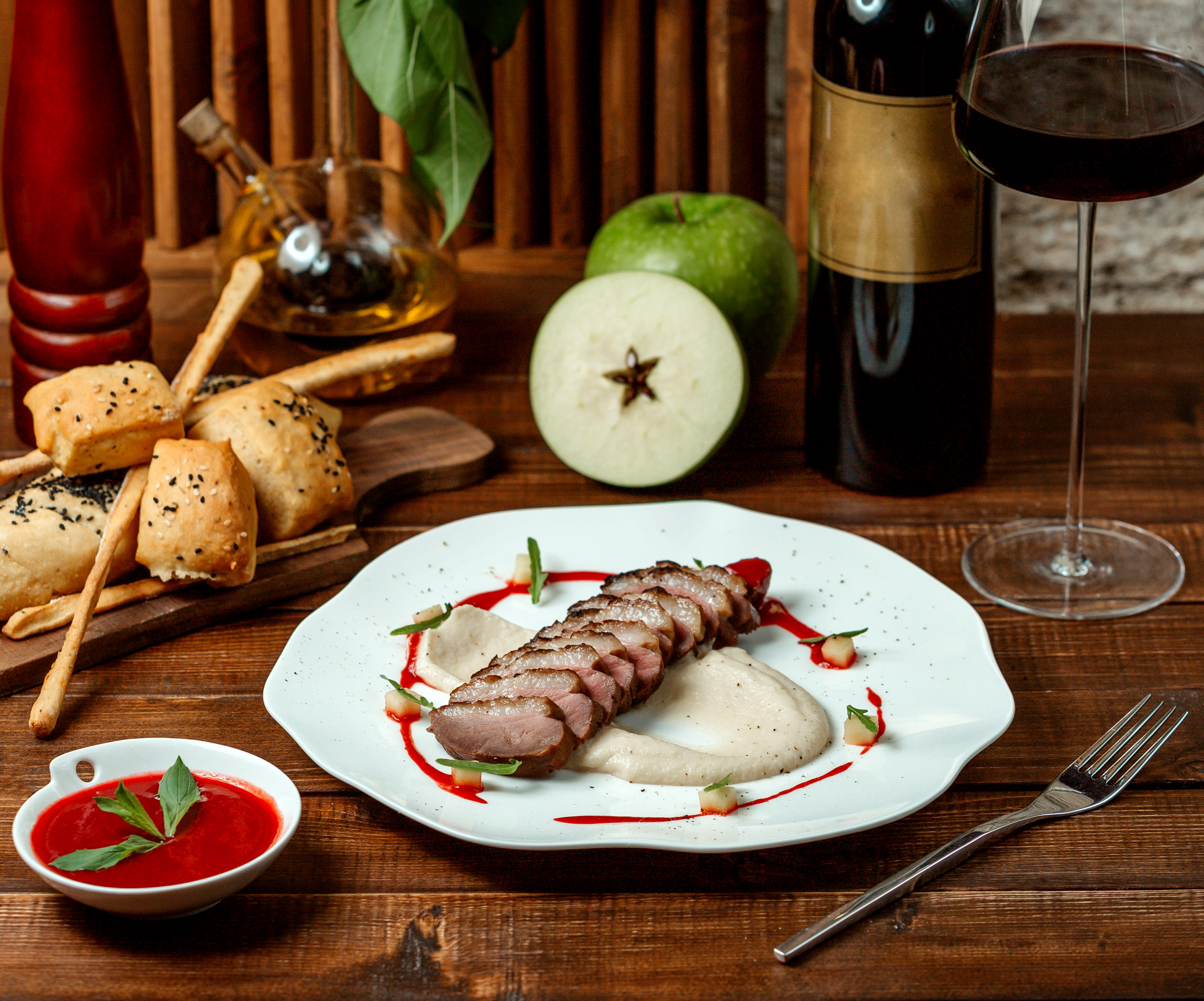 meat rings with applesauce and a glass of red wine